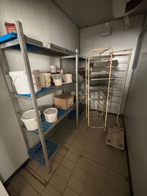a room with several shelves and a ladder in it