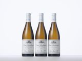 three bottles of wine sitting on top of a white table