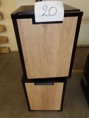 a small refrigerator with a sign on top of it
