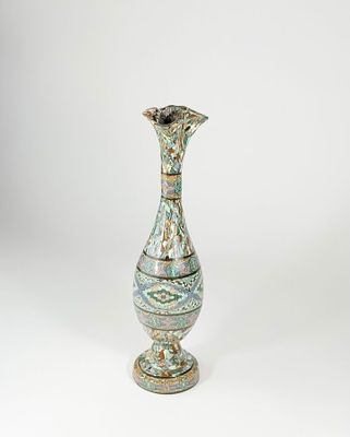 a vase that is sitting on a white surface