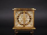 an image of a gold plated cabinet with a glass door