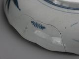 a close up of a blue and white bowl on a table