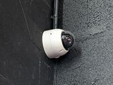 a camera attached to the side of a building