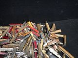 many different types of knives on a black surface