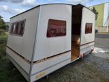 an image of a camper trailer parked in the grass