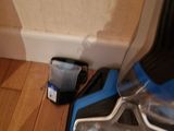 a vacuum that is sitting on the floor next to the wall