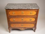 an antique chest of drawers with marble top and brass handles