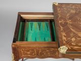 a wooden table with a green backgamzer in it