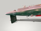 a small model of a boat on display on a white surface