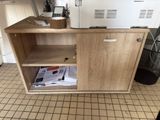 a microwave sitting on top of a cabinet in a kitchen