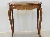 a small wooden table with a glass top on it