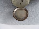 a silver clock that is sitting on top of a table