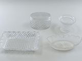 four pieces of glass on a white table