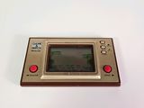 a small game console sitting on a white surface