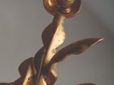 a bronze sculpture of a flower that is on display
