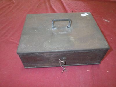 a metal box with a lock on it on a red surface