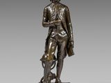 a bronze statue of a man with a dog