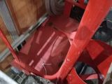 a red machine that is sitting inside of a building