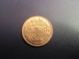 une vieille pièce d'or sur laquelle figure un blason