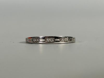 a close up of a diamond ring on a white surface