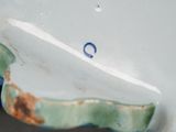 a close up of a blue and white plate with a fish on it