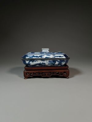 chinese blue and white porcelain box on wooden stand on grey background
