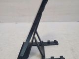 a tablet computer sitting on a stand on a table