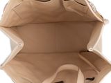 the inside of a beige purse with a handle and strap