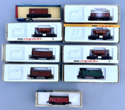 several toy train cars are lined up in a row on a table