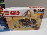 two lego star wars sets sit on a table next to each other