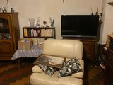 a couch and a chair in a room with a television