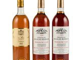 three bottles of wine sitting next to each other on a white surface
