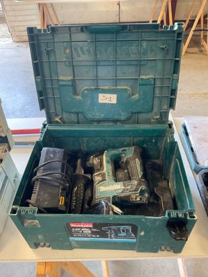 a green tool box with tools in it on a table