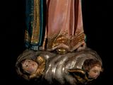 a statue of a woman holding a child in her arms