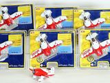 six toy airplanes are lined up in a row on a white surface