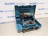 a blue tool box with a drill in it sitting on a floor