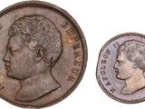a silver coin with the head of a man in profile and the head of a woman in profile