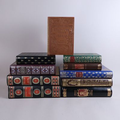 several books are stacked on top of each other on a white surface
