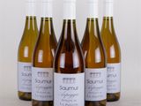 four bottles of wine sitting next to each other on a table