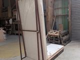 a picture of a refrigerator in a warehouse with its doors open