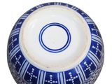 a blue and white bowl on a white surface