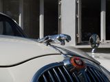 a close up of a white car with a red light on it