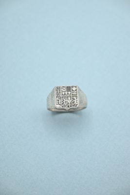 a close up of a ring with diamonds on a blue surface