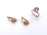three rings and a ring with a pink stone on a white background