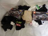 a pile of clothing and toys on a bed