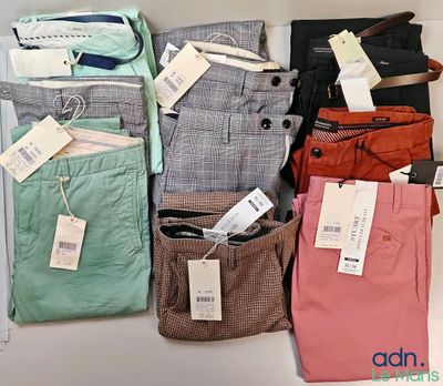 a lot of men ' s pants on display on the table