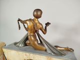 a statue of a woman sitting on top of a clock