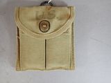 a small tan pouch with a metal button on it