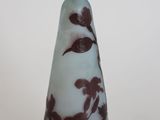 a glass vase with a brown and white design on it