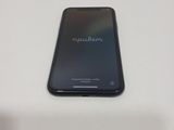 the back of a black cell phone sitting on top of a white table
